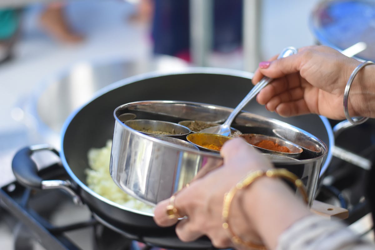 A local home-kitchen partner preparing a fresh Indian meal